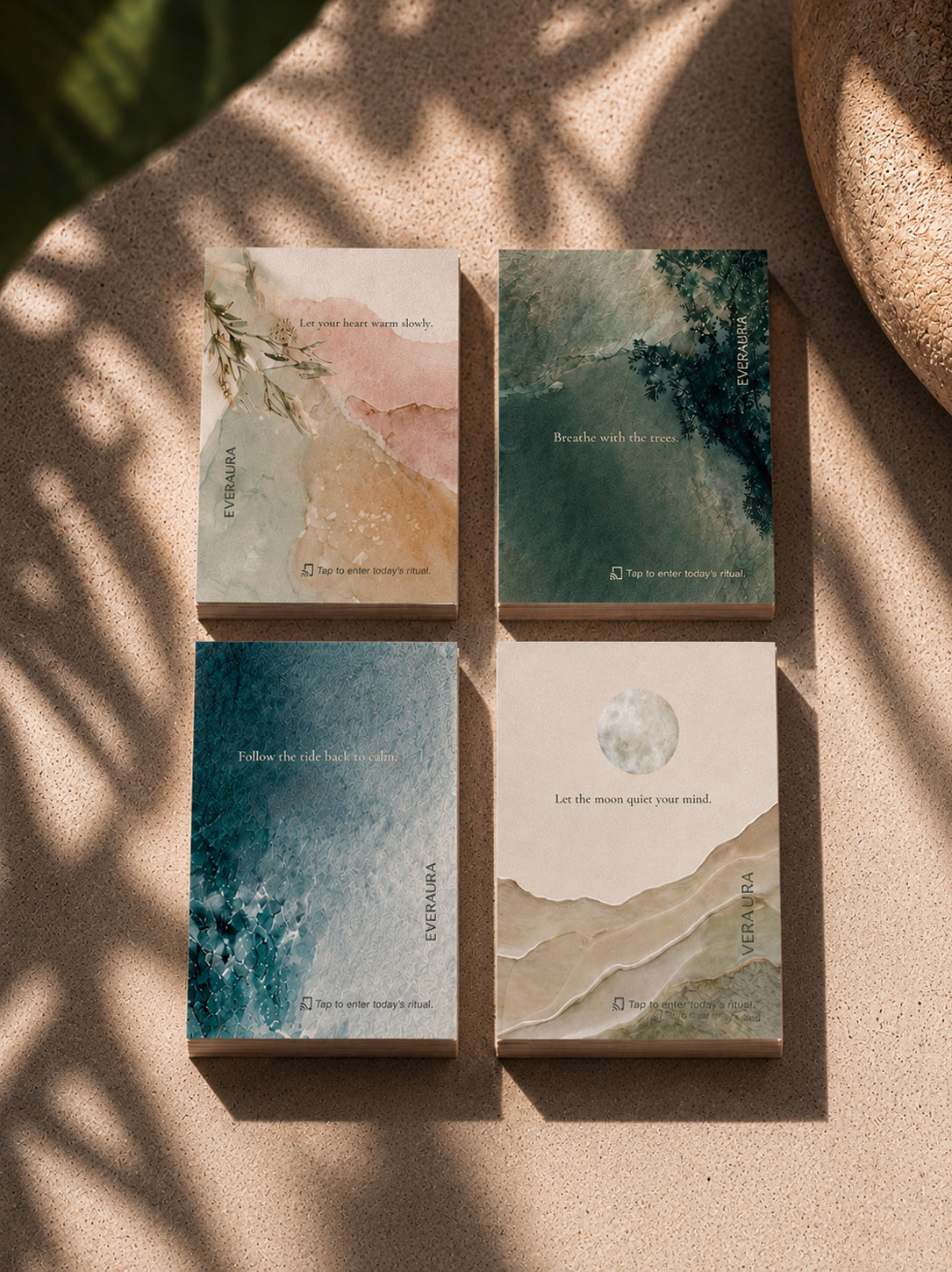 EverAura Four Energies Ritual Card Set, all four cards laid flat in warm dappled light, Radiant Heart, Grounding, Ocean Healing and Moon Water. Four one minute nature meditation scent cards.