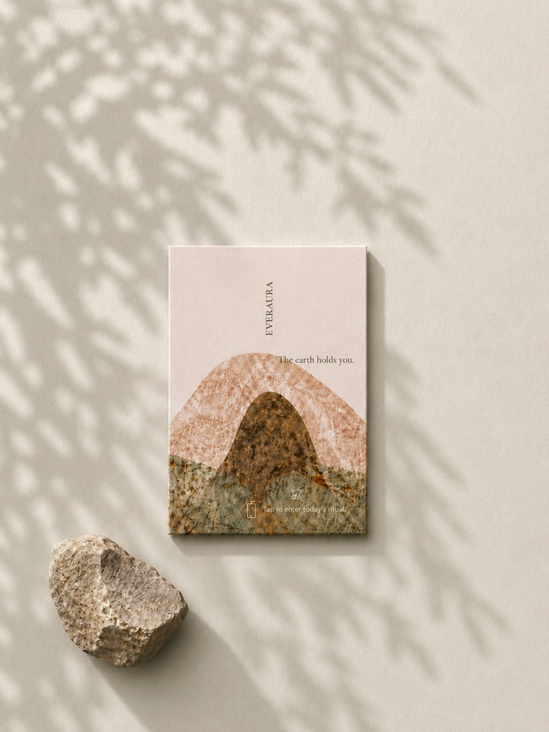 EverAura Grounding ritual card, The earth holds you, a stone and mountain design beside a rock. A grounding nature meditation scent card.