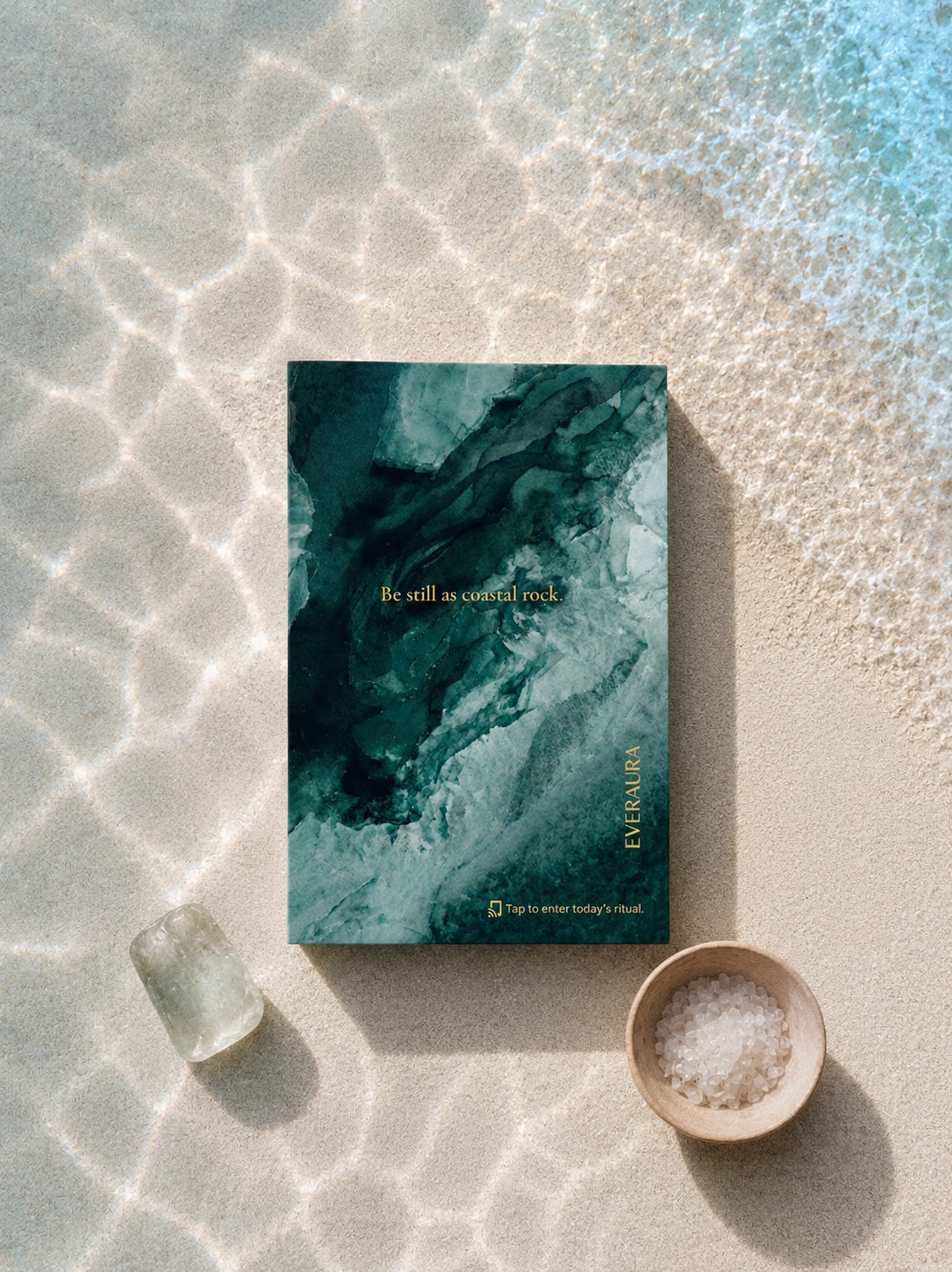 EverAura Ocean Healing ritual card, Be still as coastal rock, styled on sunlit sand with a crystal and a bowl of sea salt. A one minute nature meditation and scent card.