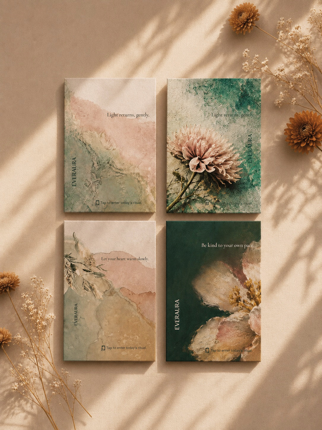 The four EverAura Radiant Heart ritual card designs laid together with dried flowers in warm light. Let your heart warm slowly, Light returns gently, and Be kind to your own pace.