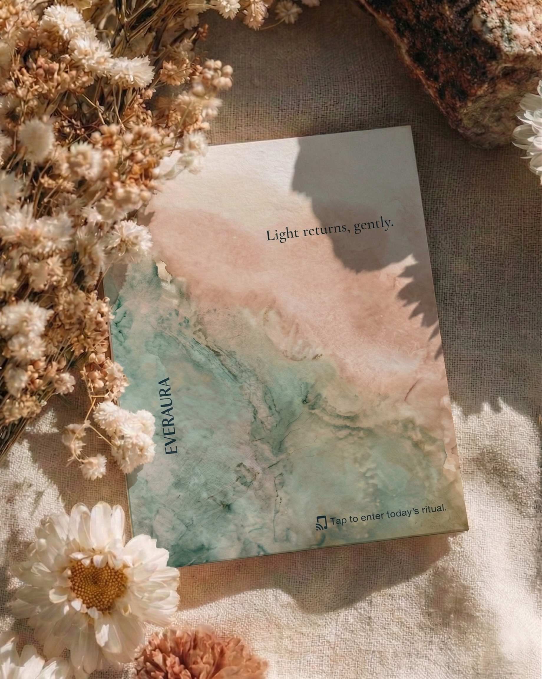 EverAura Radiant Heart ritual card, Light returns gently, styled on soft linen with daisies and dried flowers. A daily nature meditation and scent card.