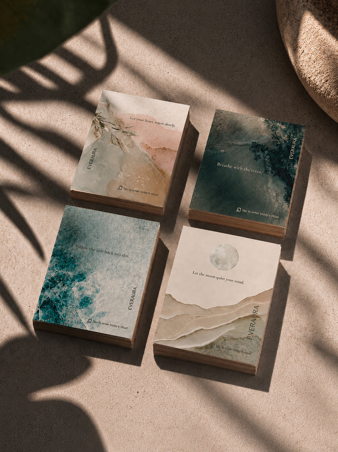 EverAura Four Energies Ritual Card Set, the four cards arranged together on a sunlit textured surface under leaf shadow. Four one minute nature meditation scent cards.