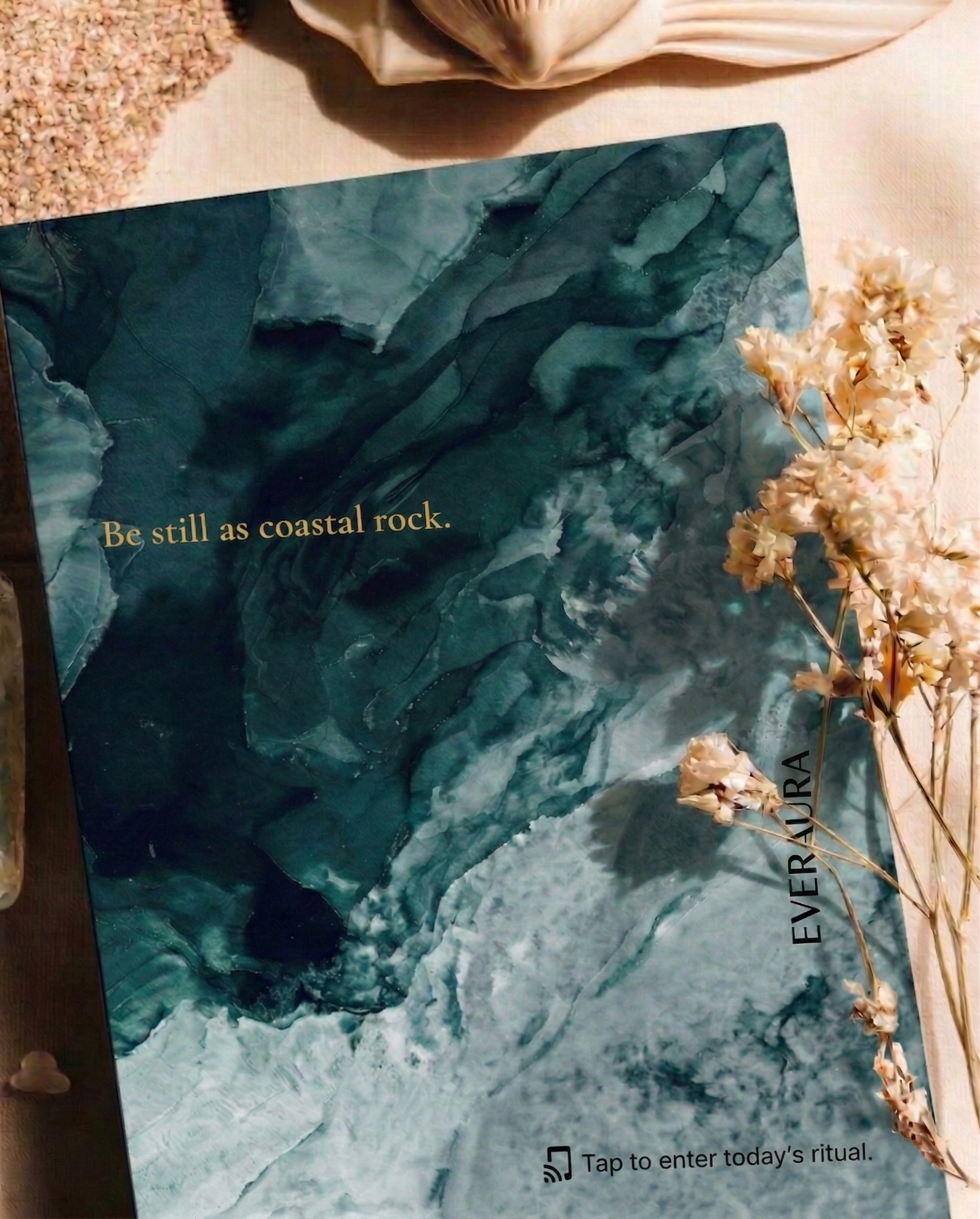 EverAura Ocean Healing ritual card, Be still as coastal rock, a deep teal ink design styled on sand with dried flowers. A one minute nature meditation and scent card.