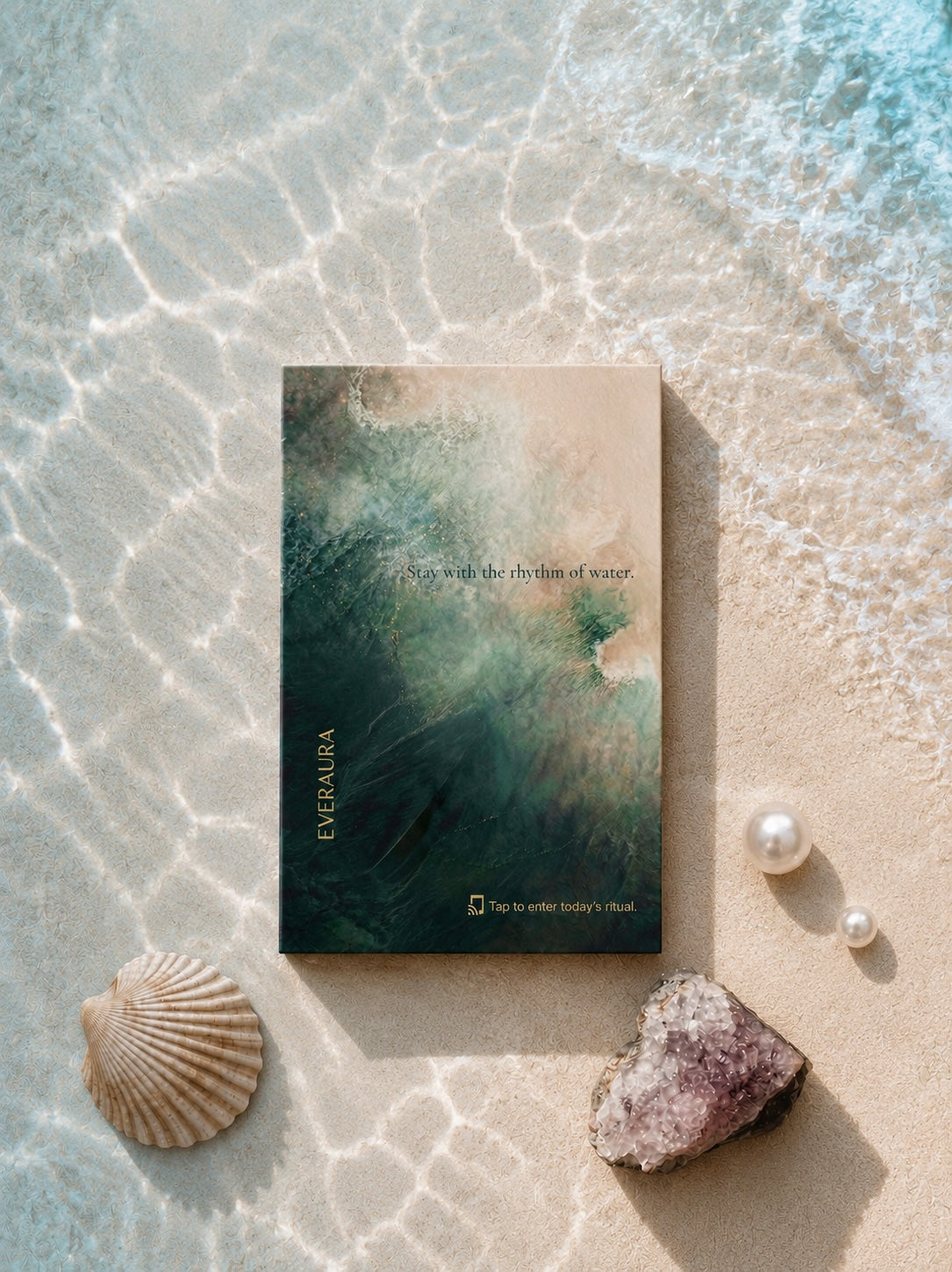 EverAura Ocean Healing ritual card, Stay with the rhythm of water, styled in shallow water on sand with a shell, pearls and an amethyst geode. A one minute nature meditation and scent card.