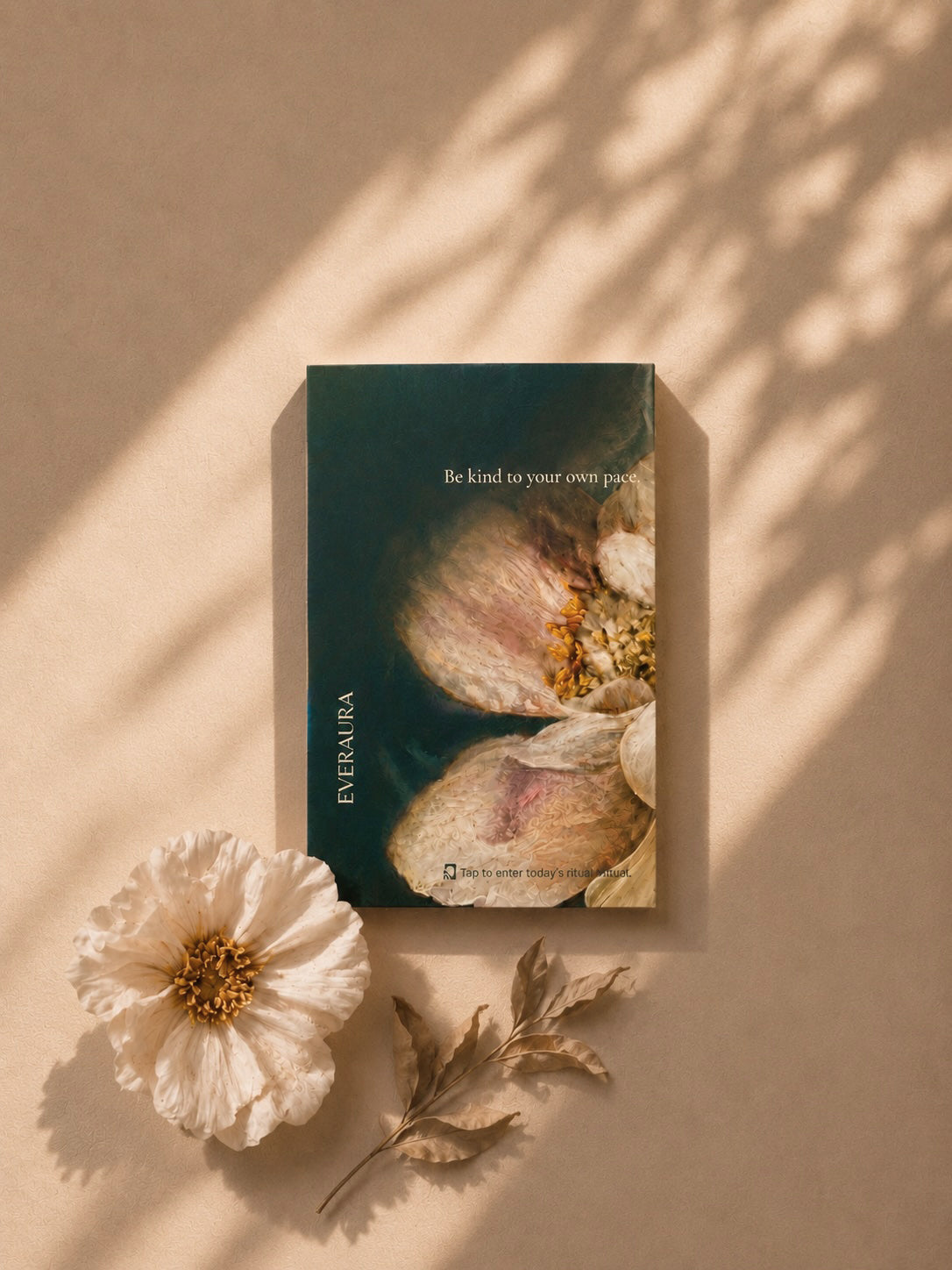 EverAura Radiant Heart ritual card, Be kind to your own pace, styled with a white bloom and dried leaves in warm light. A daily nature meditation and scent card.