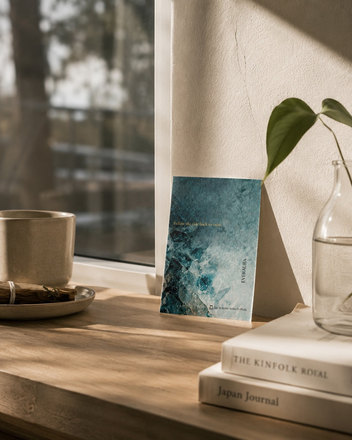 EverAura Ocean Healing ritual card on a sunlit windowsill beside a coffee cup and books. Follow the tide back to calm, a daily one minute ocean meditation.